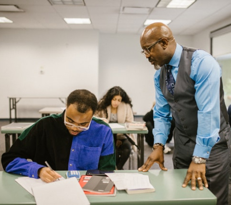 Teacher Proctoring His Students During an Examination